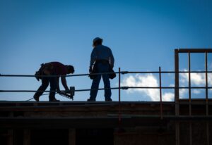 Construction Workers Silhouette on Roof